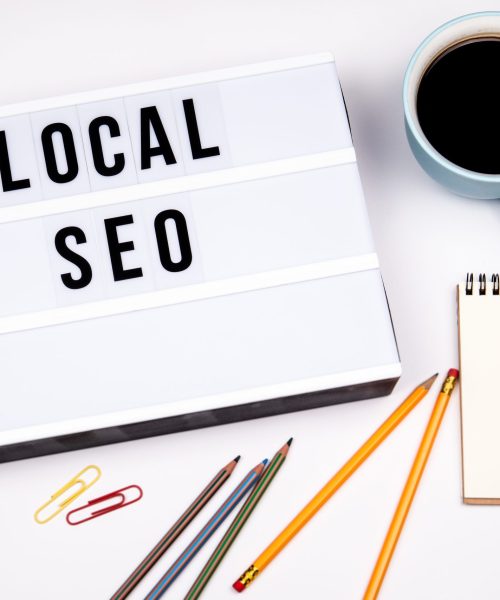 local seo text in lightbox white desk with stationery